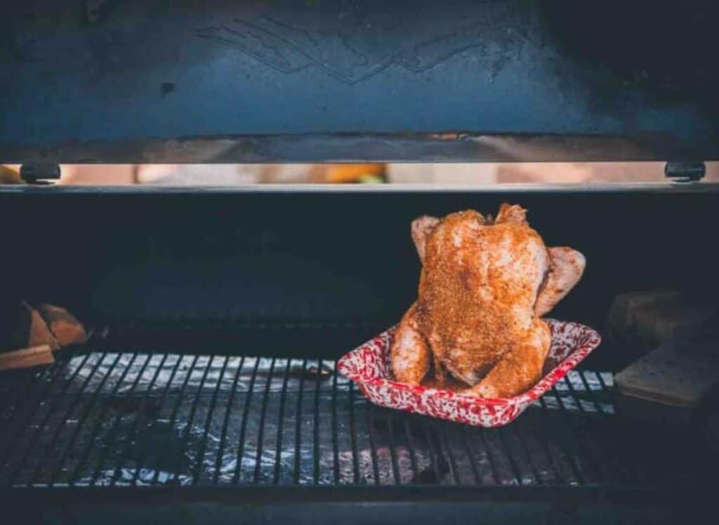 Beer can chicken on a grill.