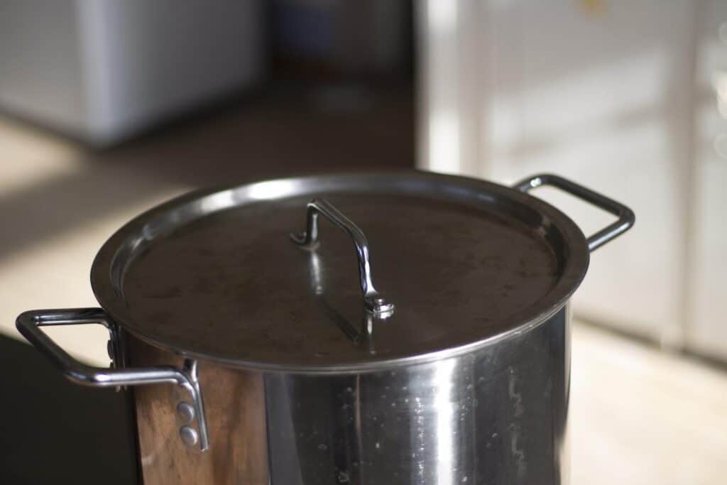 A large pot and lid with a blurred background.