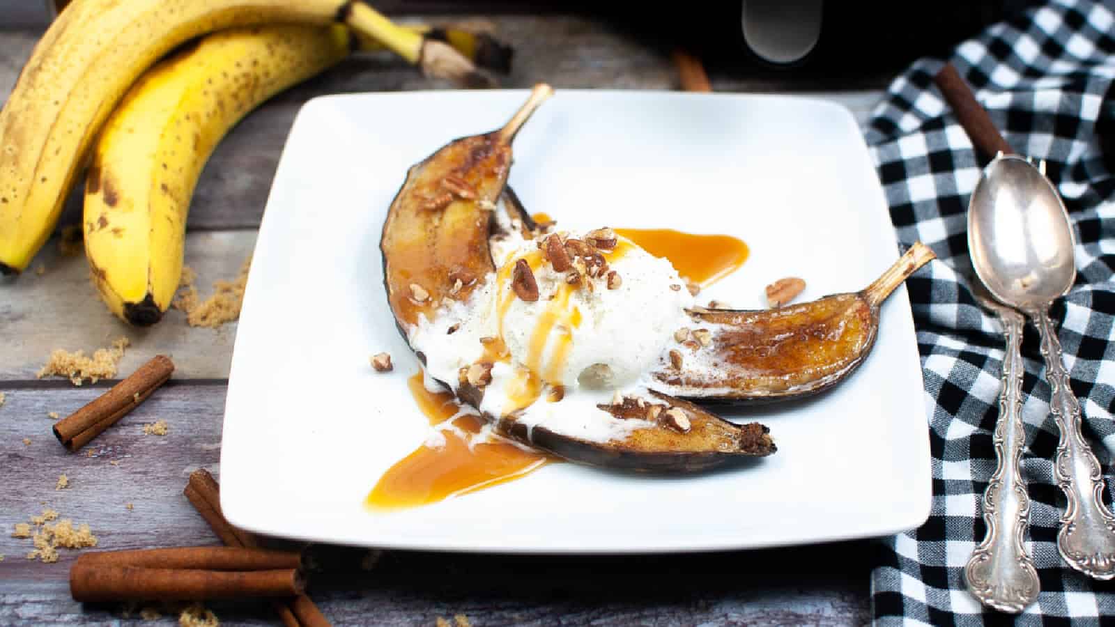 Overhead shot of air fryer caramelized bananas with caramel sauce and vanilla ice cream.