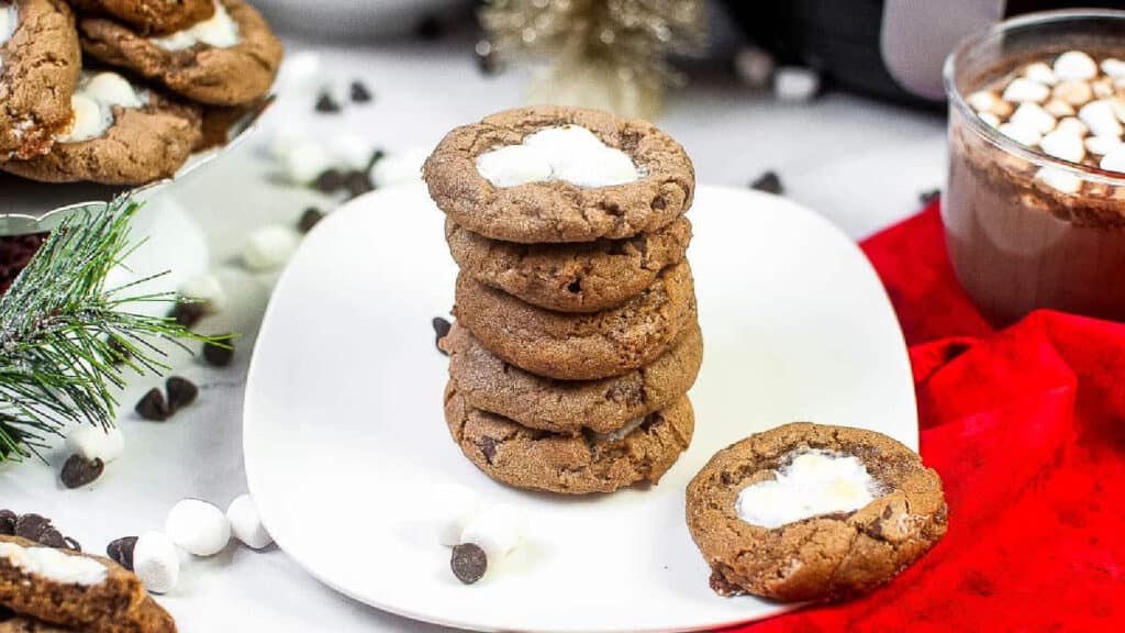 A stack of air fryer hot cocoa cookies on a white plate.