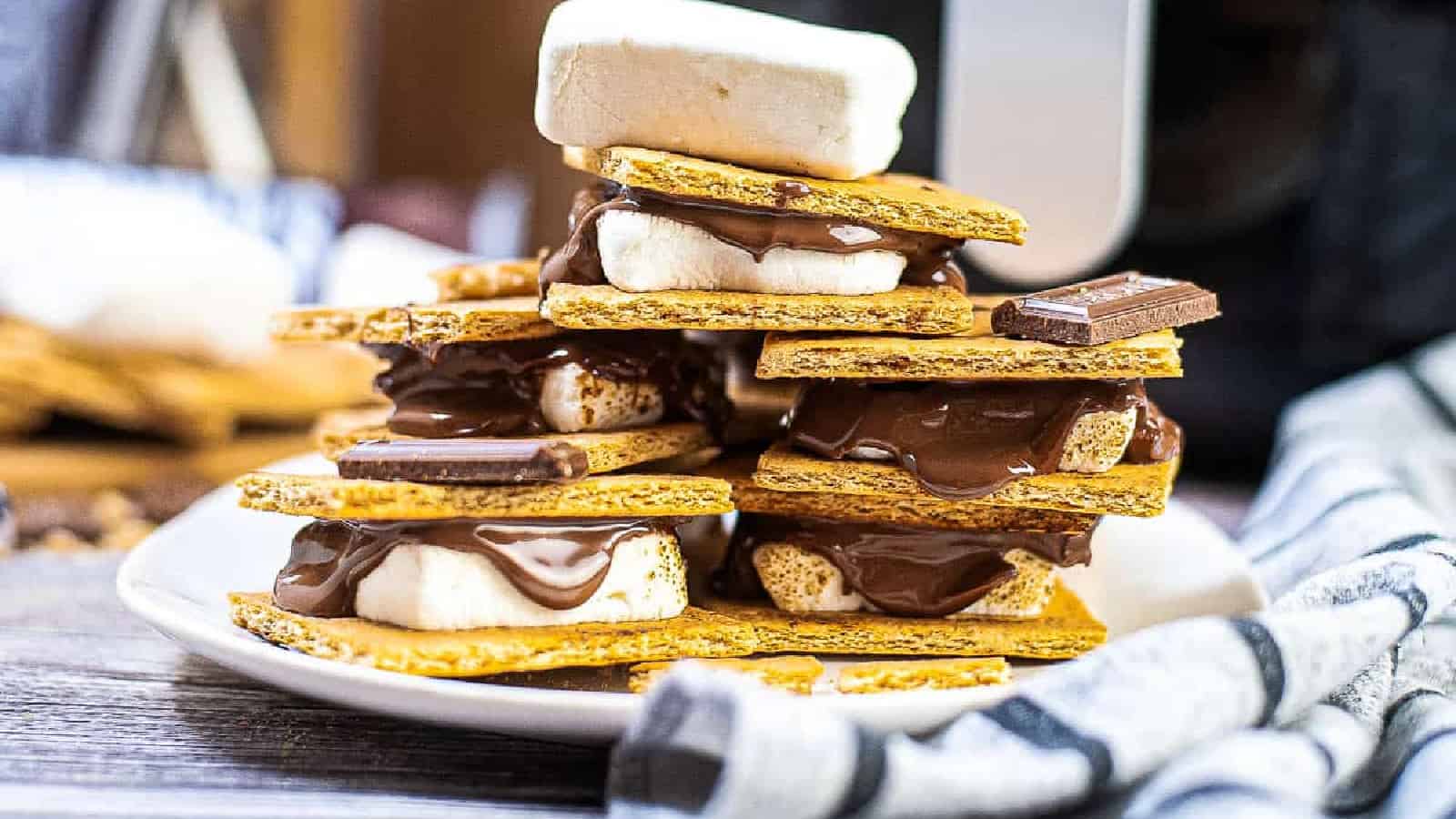 Stacked s'mores on a white plate.