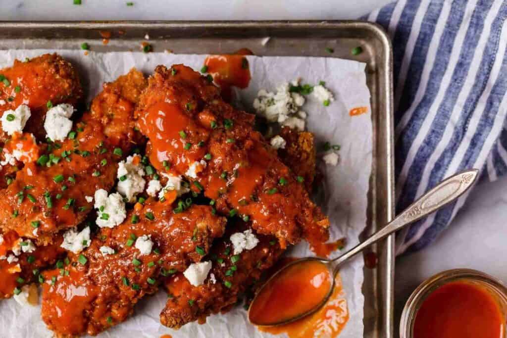 Keto buffalo chicken tenders on a sheet pan.