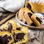 Marble Chocolate Bundt Cake cut into slices on a wooden table.