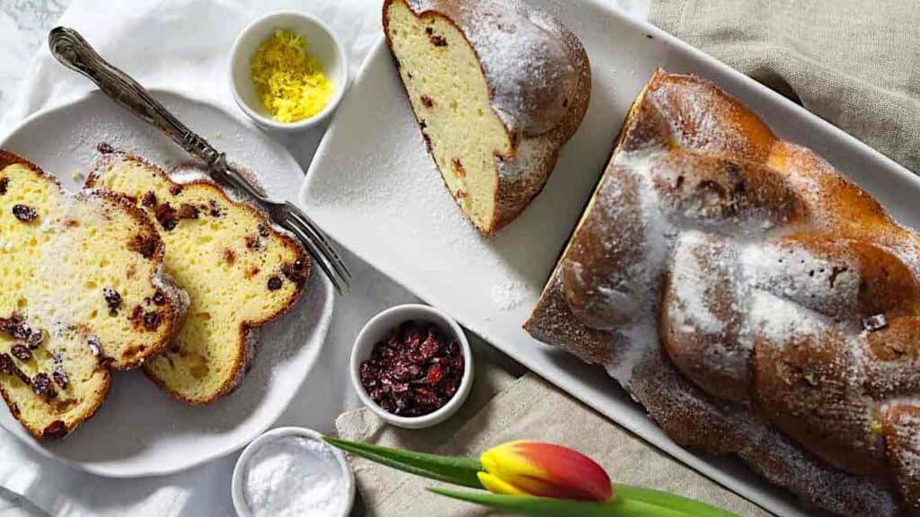 Sweet Low Carb Challah Bread on a white plate with tulips.
