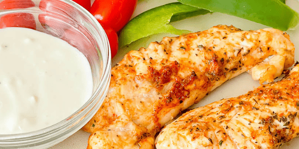 Grilled Chicken Tenders on a plate with ranch dipping sauce and bell pepper strips.