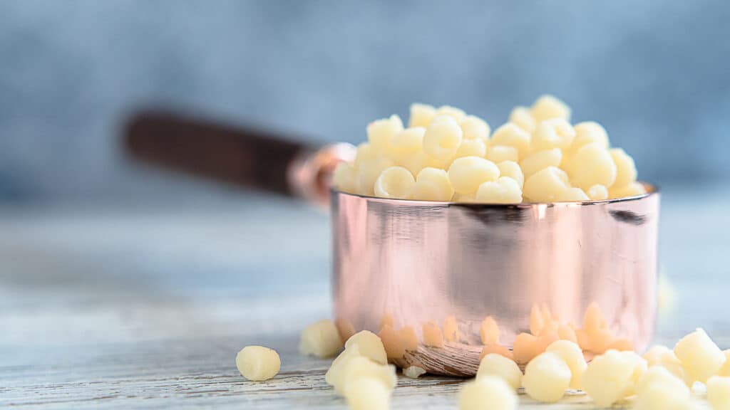 Sugar-Free White Chocolate Chips inside measuring cup. 