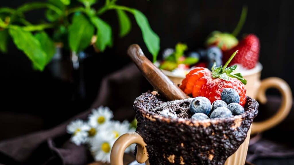 Chocolate Mug Cake with berries on top.