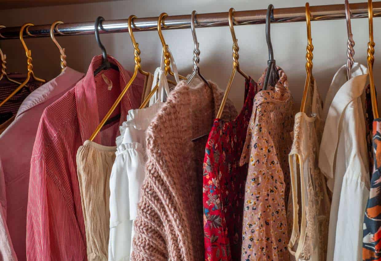 Clothes on hangers in closet.
