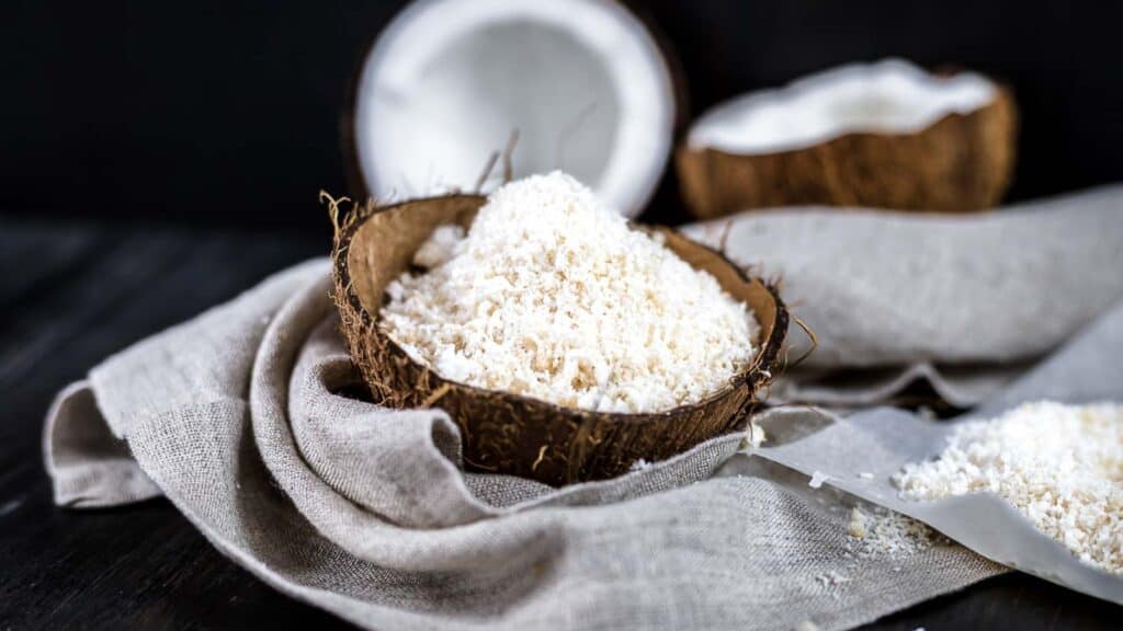 Shredded Coconut inside coconut bowl. 
