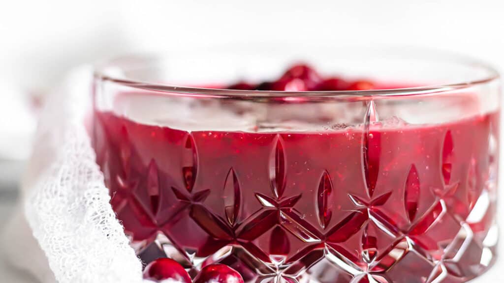 Cranberry sauce in a glass container.