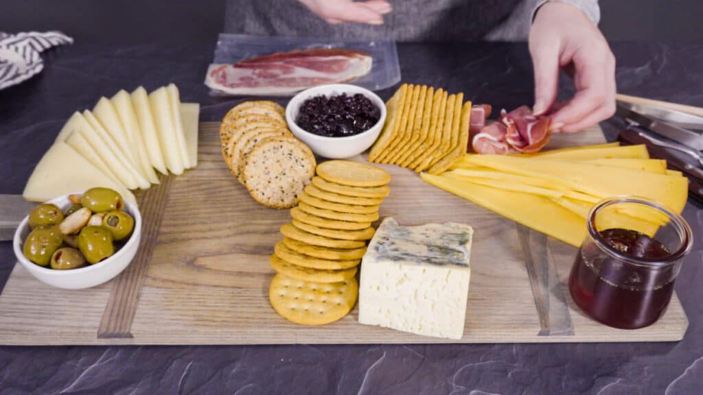 Arranging a meat and cheese board.