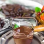 Sugar-Free Chocolate Magic Shell in a glass with berries behind.
