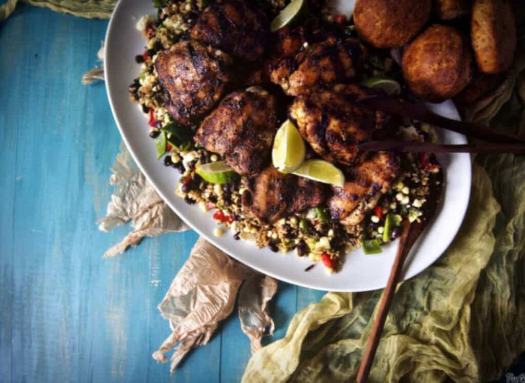 Grilled chicken thighs on a platter.