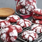 A cooling rack with red velvet crinkle cookies.