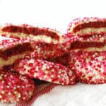 Red velvet stuffed cookies on a white and red towel.