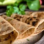 Fiber tortillas layered on a brown plate ready to consume.