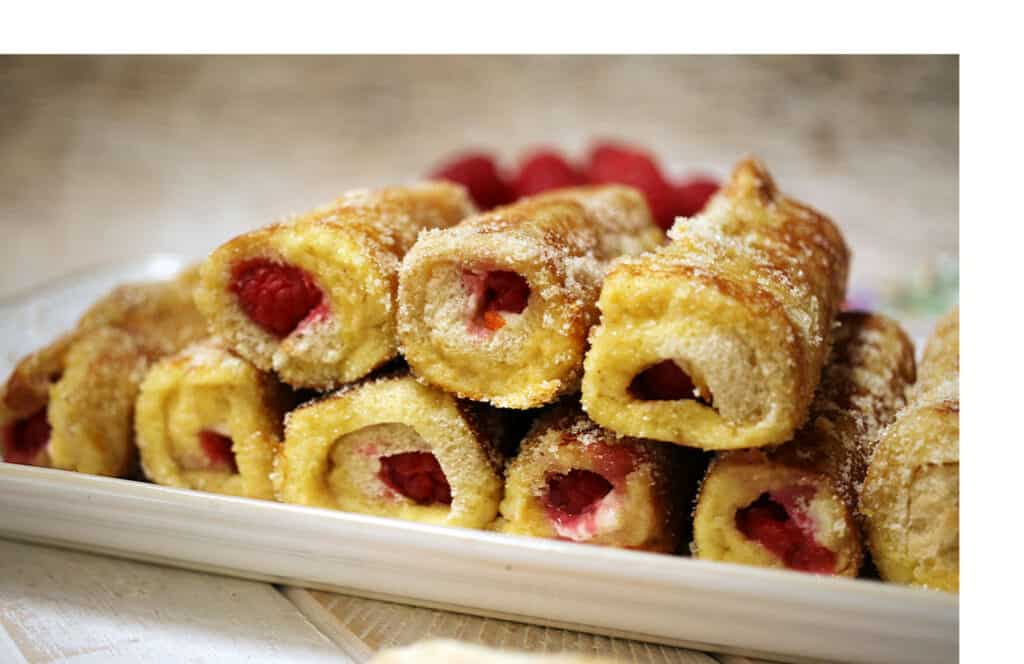 A white platter with raspberry French toast rolls.