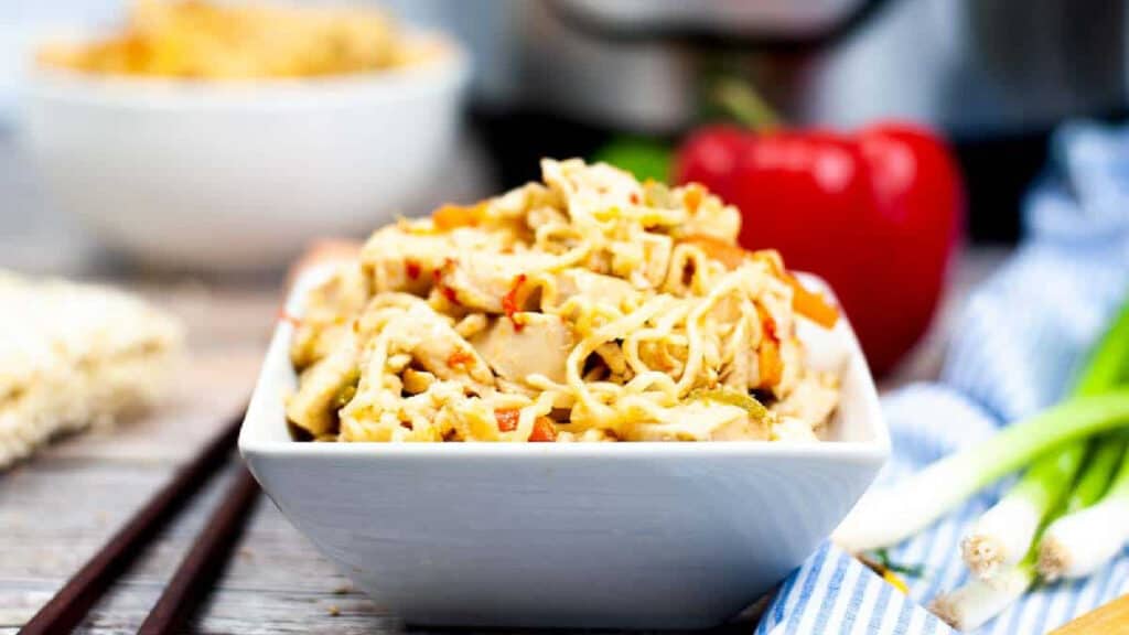 Ramen noodles stir fry in a white bowl.