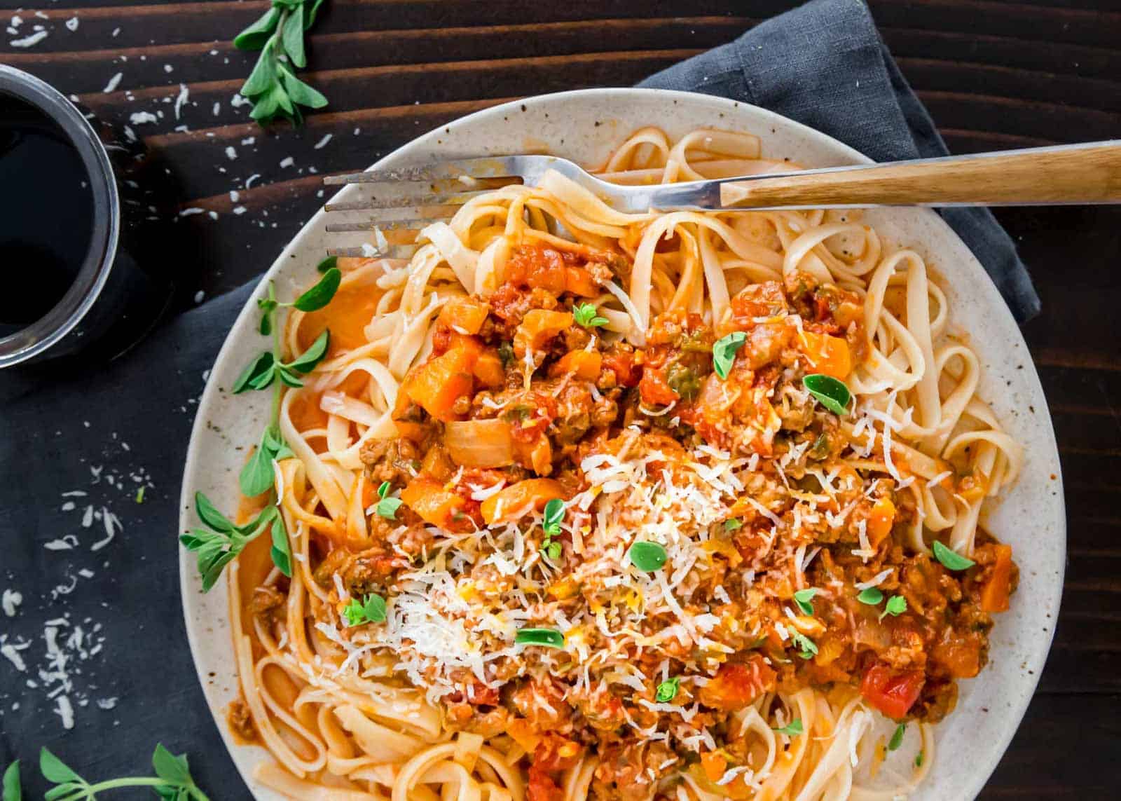 Instant Pot bolognese recipe on a plate with a fork.
