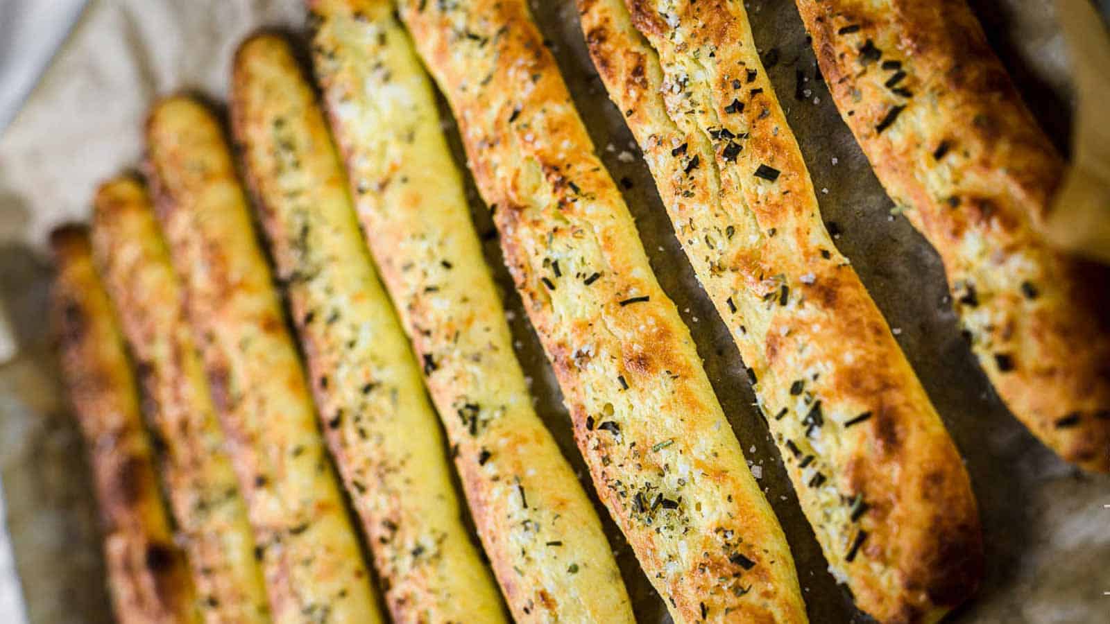 Italian breadsticks on a baking tray. 