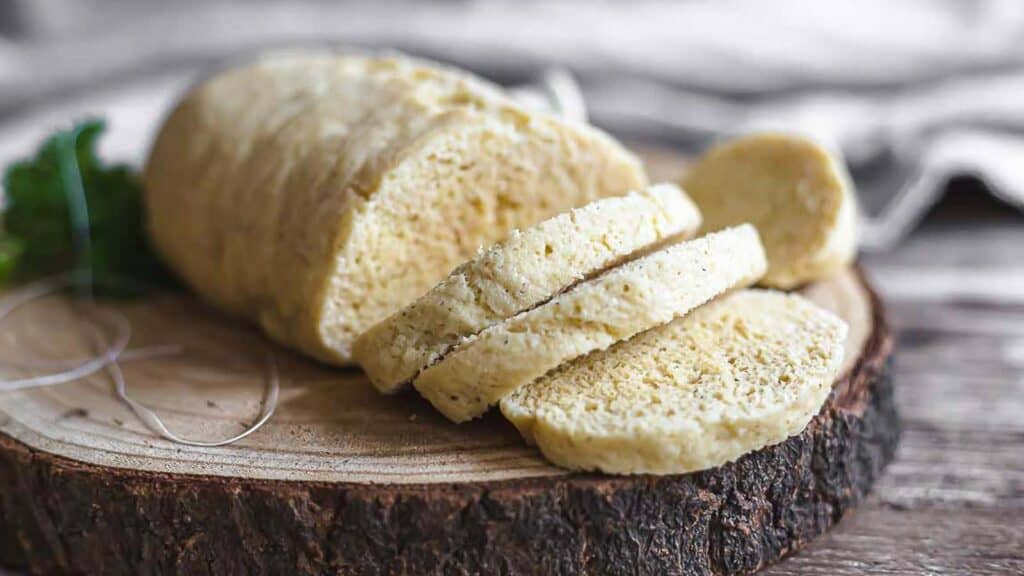 Low Carb steamed bread on a wooden board sliced.