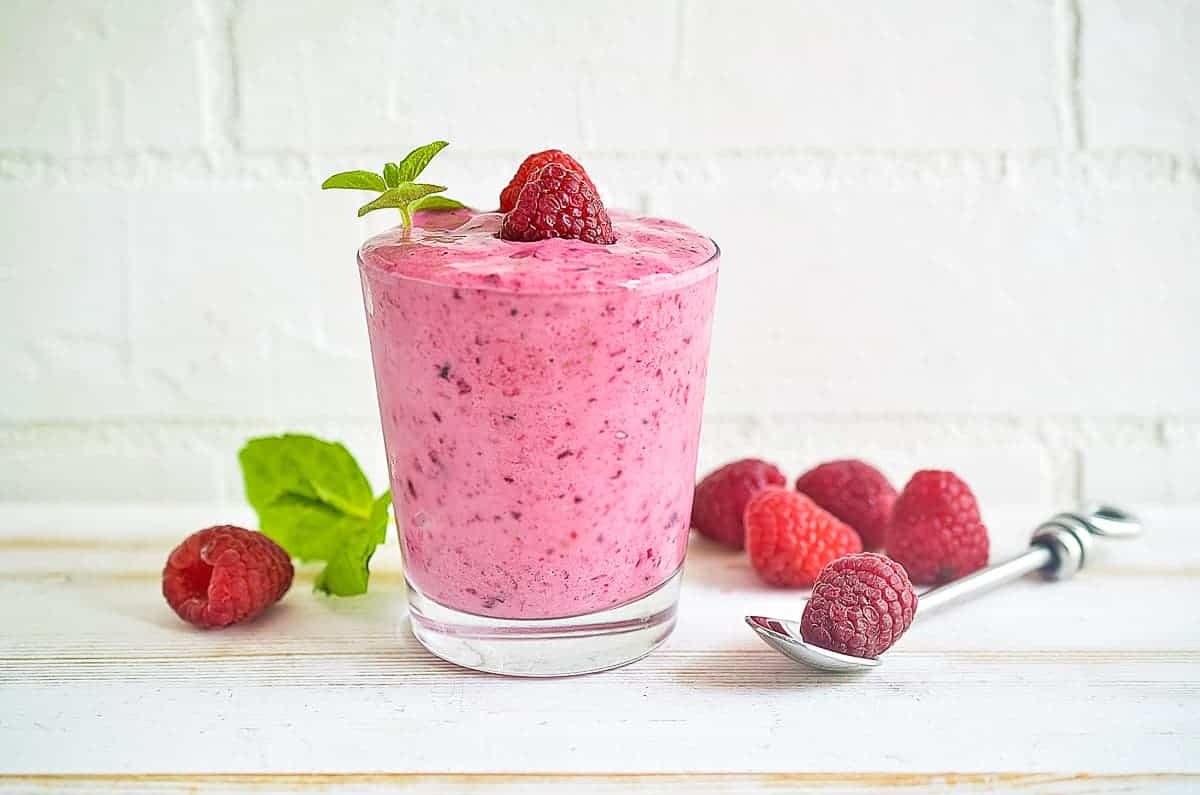 A raspberry smoothie in a glass.