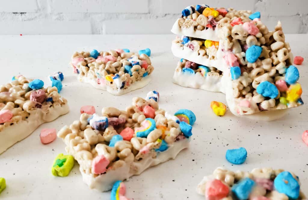 Slices of Lucky Charms bars on a white board.