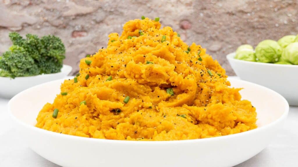 Mashed sweet potato in a serving bowl.