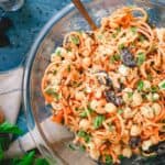 Mediterranean carrot salad with white beans and raisins in a glass bowl.