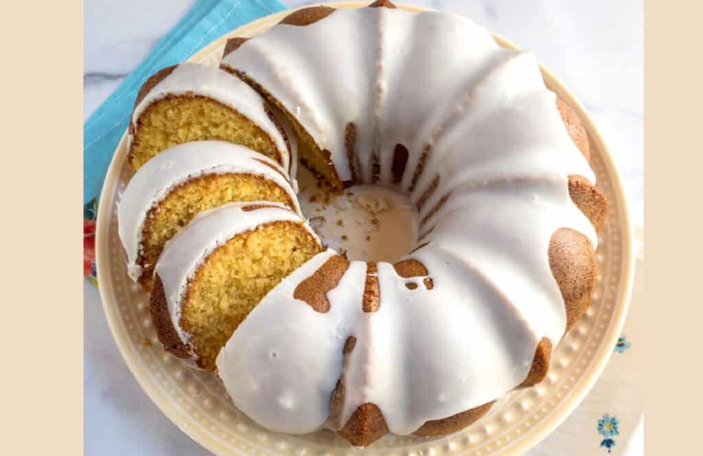An overhead view of an iced Mountain Dew bundt cake on a yellow plate.