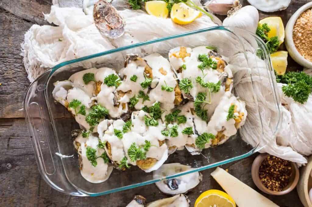 Oyster bake casserole on table with linen and herbs