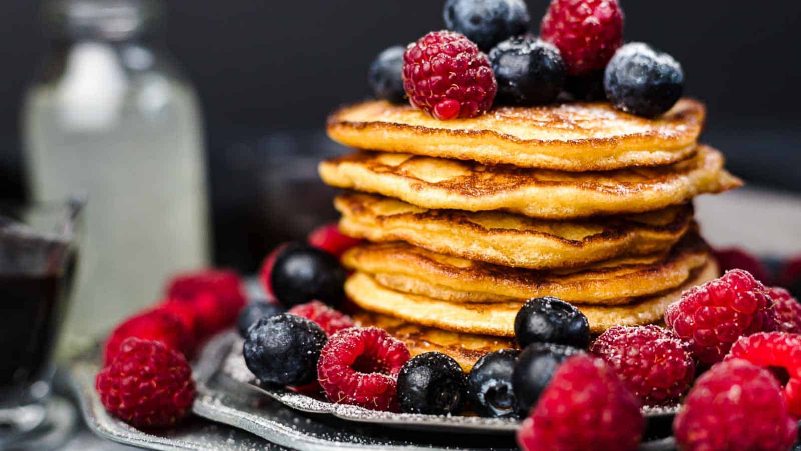 Keto Pancakes on top of each other with berries. 