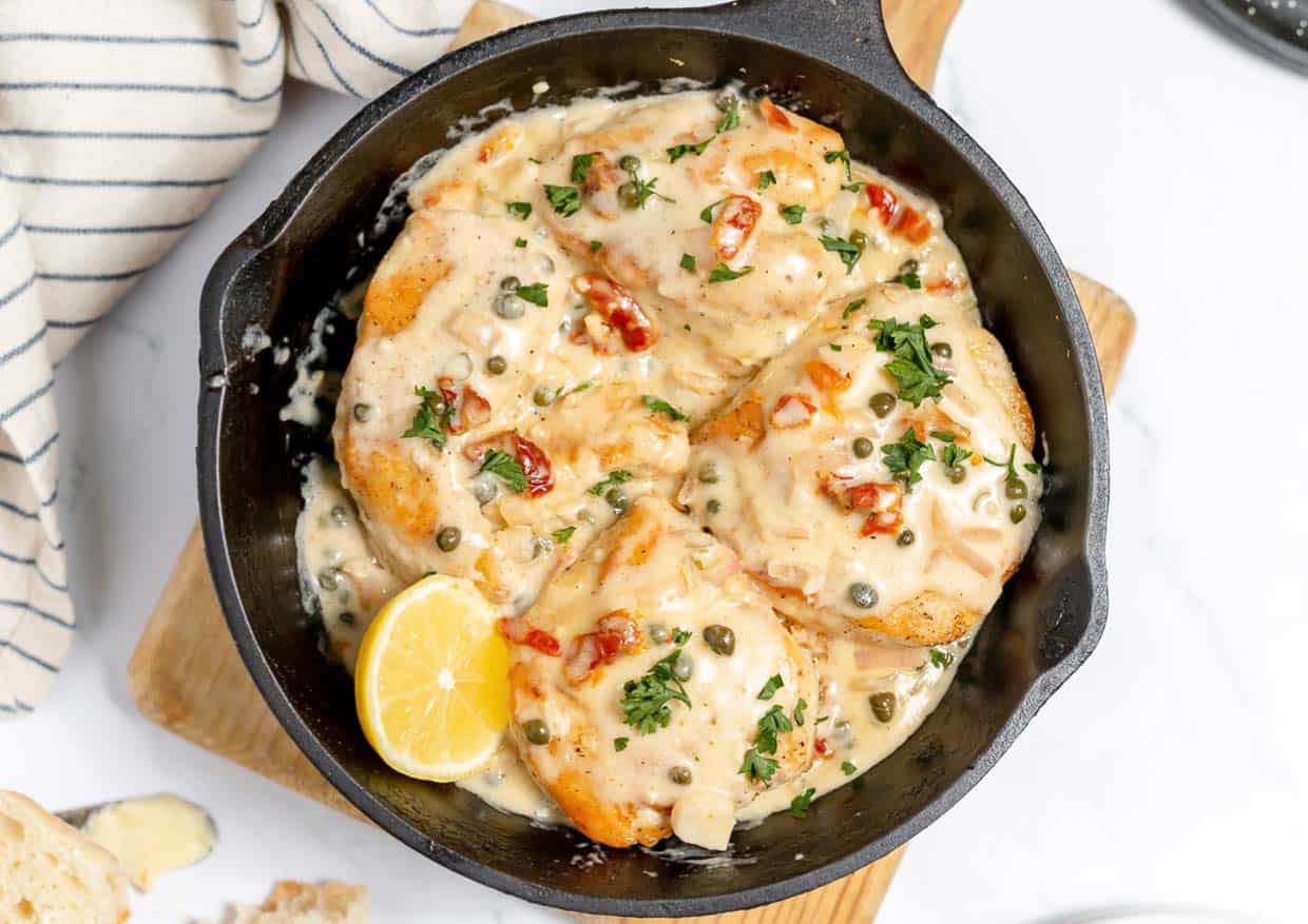Easy chicken piccata in a cast iron skillet on a linen.