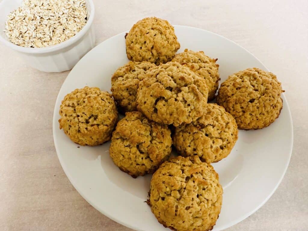 Oatmeal Cookies on White Plate with bowl of oats in background