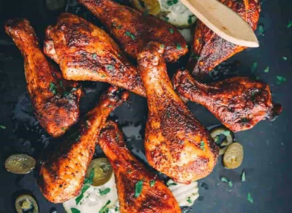 Pile of smoked drumsticks.