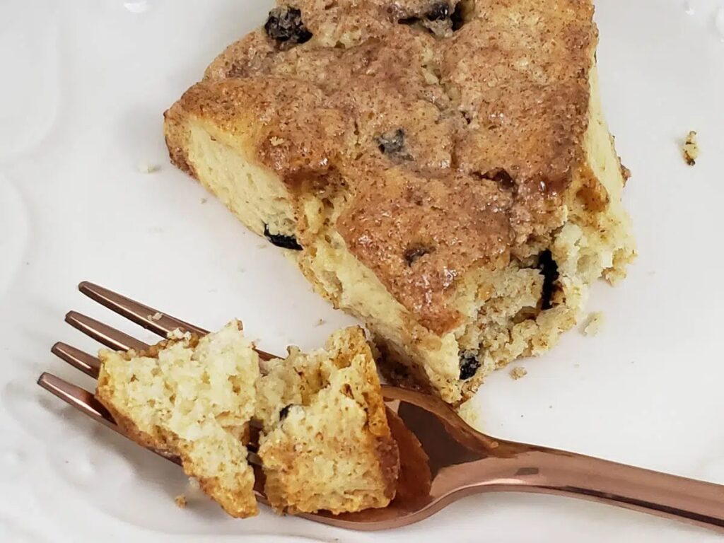 Slice of sourdough cherry scone with a fork.