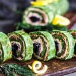 Spinach Salmon Rolls on a wooden board.