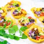 Easy Crunchy Keto Taco Cups on a white board with cilantro.