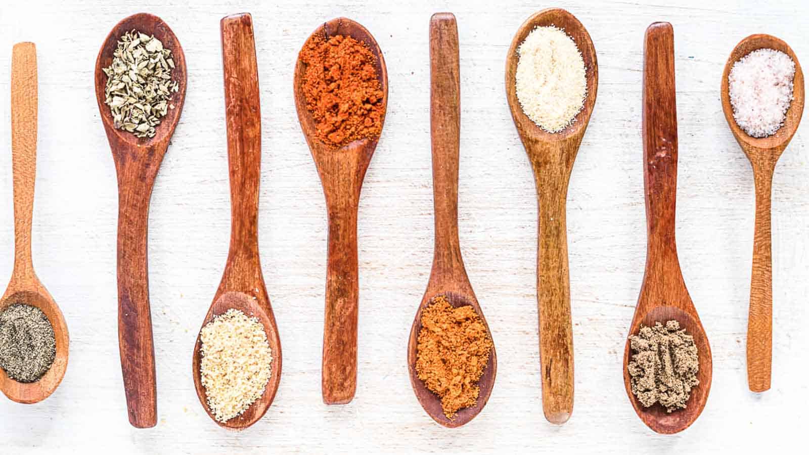 Gluten Free Taco Seasoning spices on a wooden spoons. 