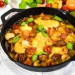 Tomato Mozzarella Baked Chicken inside cast iron.