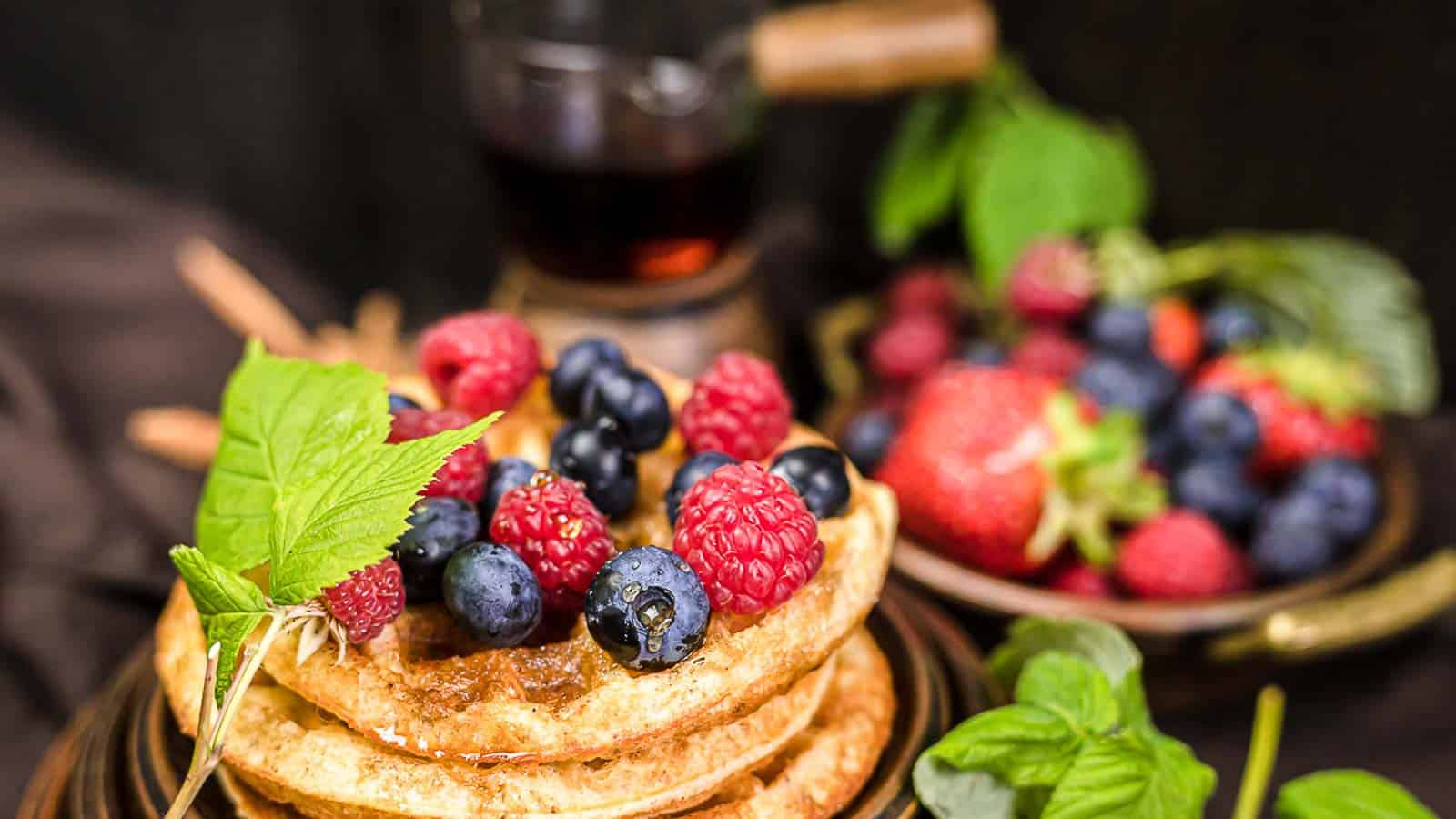 Sweet Cinnamon Cream Cheese Chaffle on a plate with berries. 
