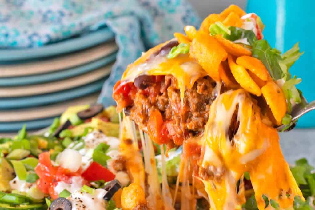 Walking Taco Casserole being scooped out of the baking dish.