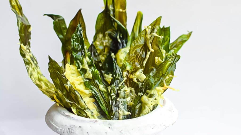 Wild Garlic Greens Chips in a pot with cheese.