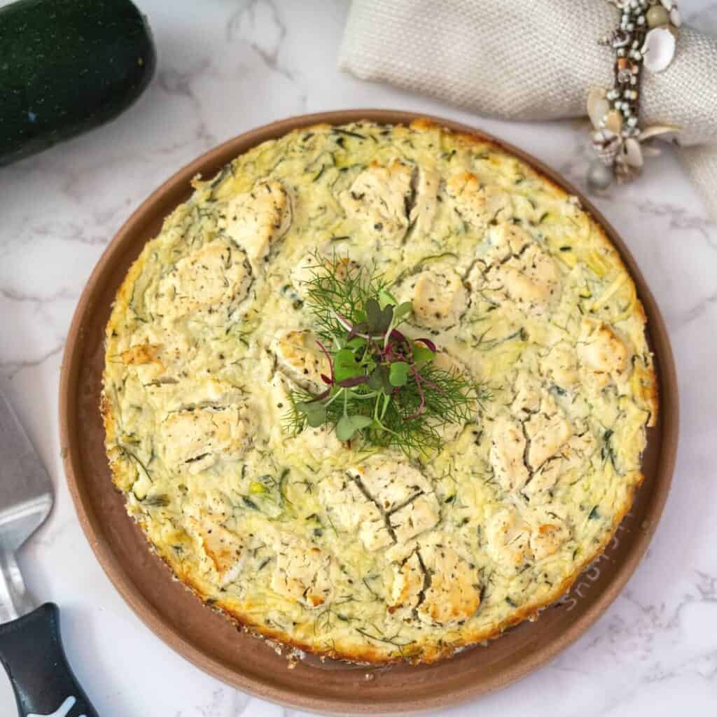 Zucchini ricotta cheesecake on a circular plate.