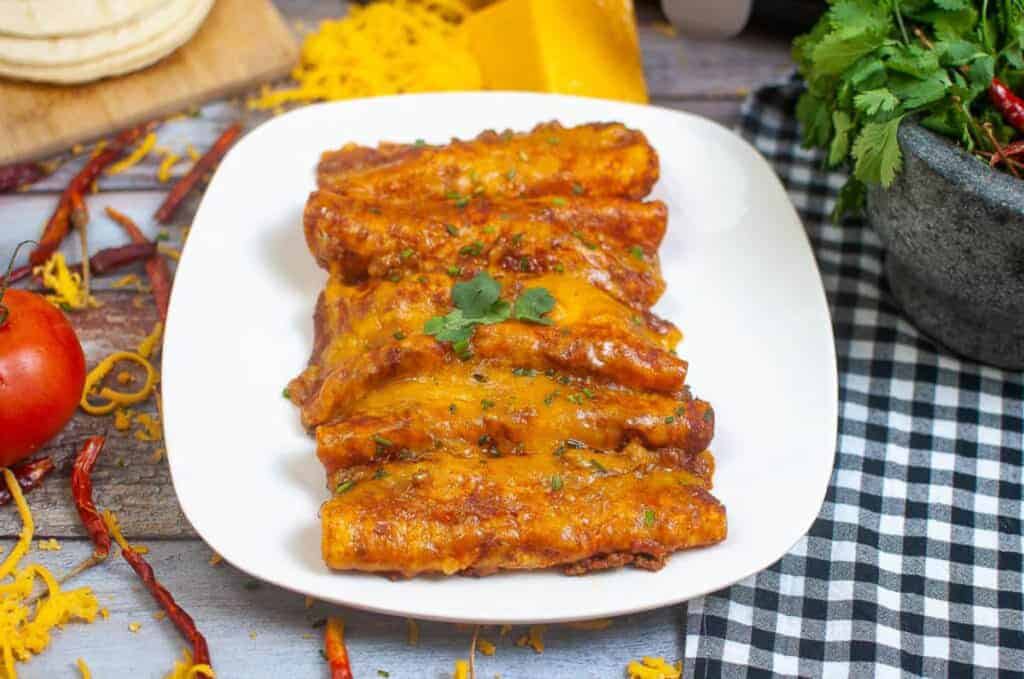 Enchiladas on a white plate.