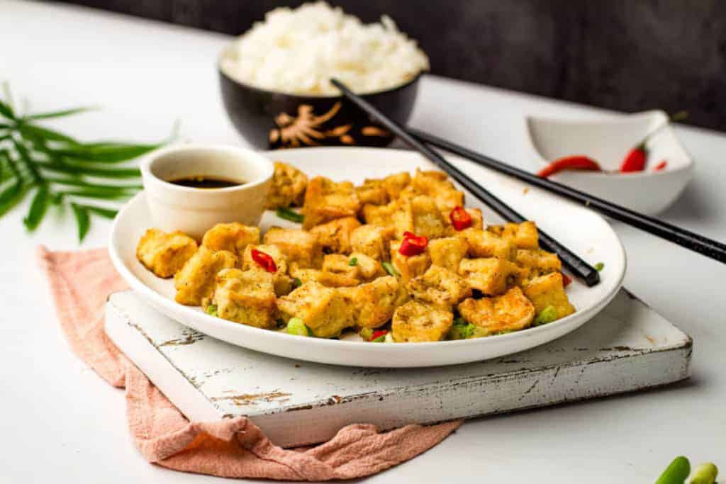 Air fried tofu on a white plate.