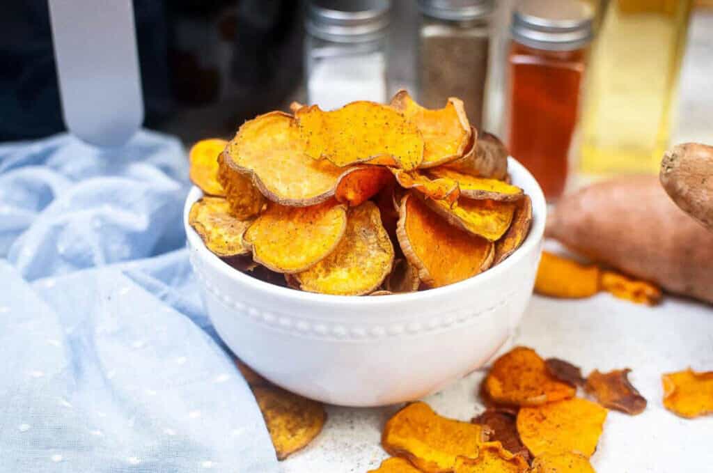 white bowl filled with sweet potato chips.