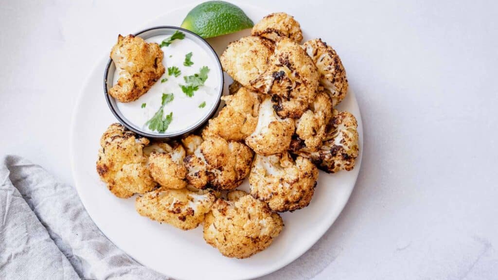 A white plate filled with air fryer cauliflower.