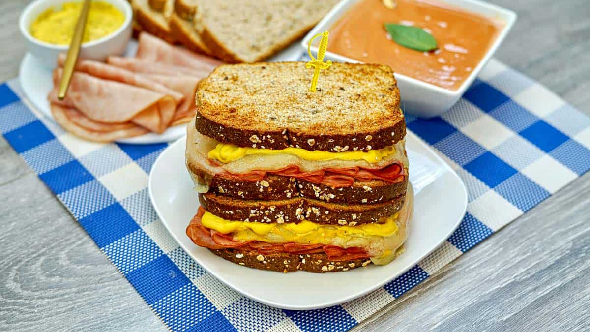 air fryer ham and cheese sandwich on a blue tablecloth.