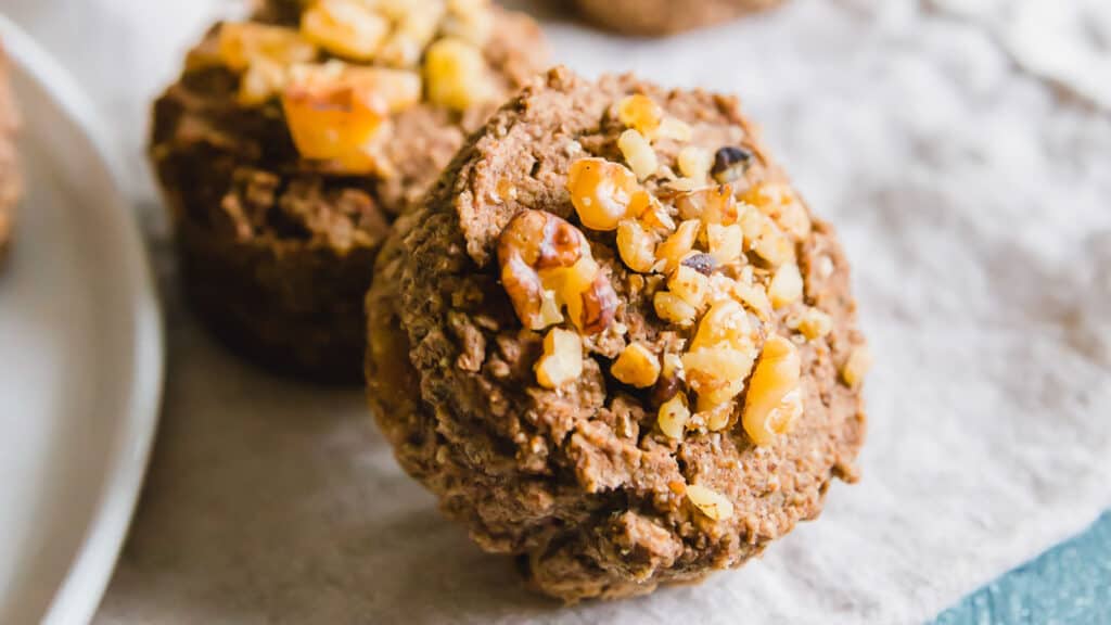 Banana nut almond muffins on parchment paper.